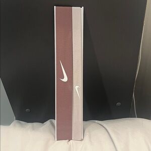 Nike mauve and soft pink headbands with white swoosh